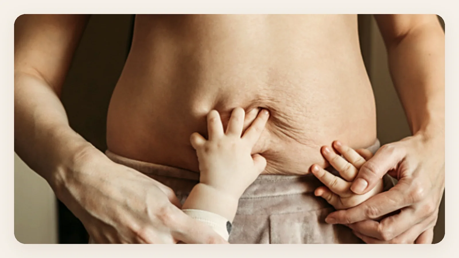 Mother holding her baby against her postpartum belly, comfortable and pain free