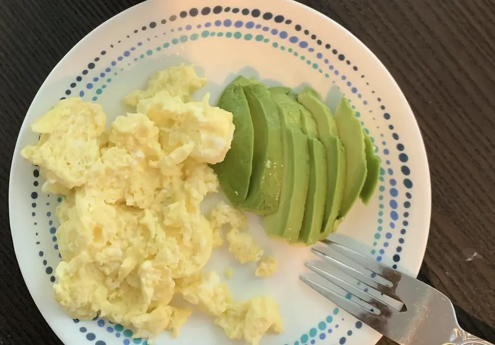 Scrambled eggs and avocado, a simple protein and healthy-fat breakfast