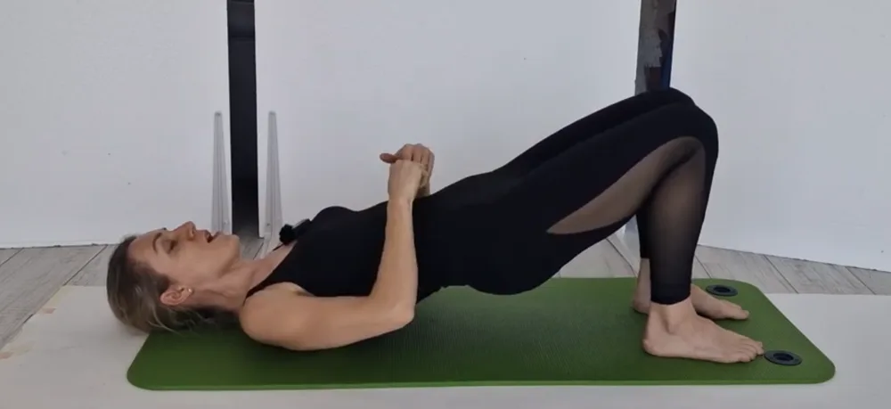 Ana demonstrating a pelvic floor bridge exercise