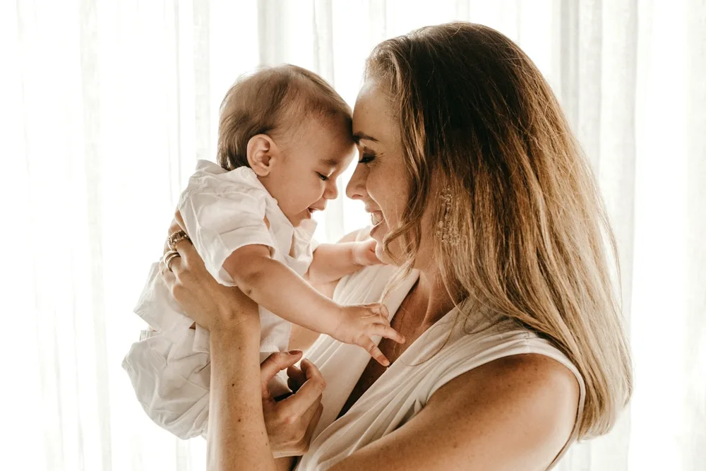 A mother and baby, foreheads together