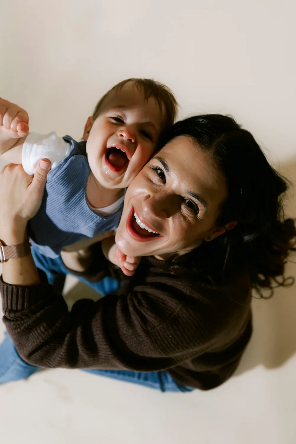 A mother laughing with her baby